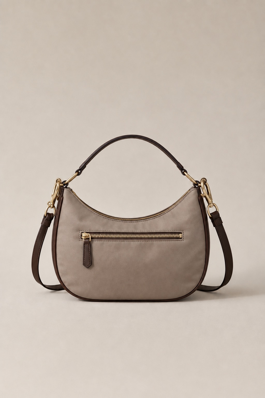 The Lumen crossbody from behind, showing the hidden zipped passport pocket set into the back panel.